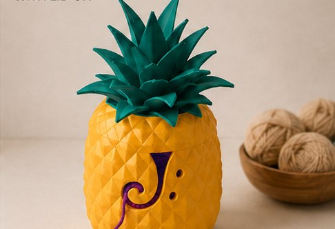 The pineapple yarn bowl with its teal leaf lid on.