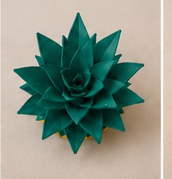 Top-down view of the teal leaf lid on its own.